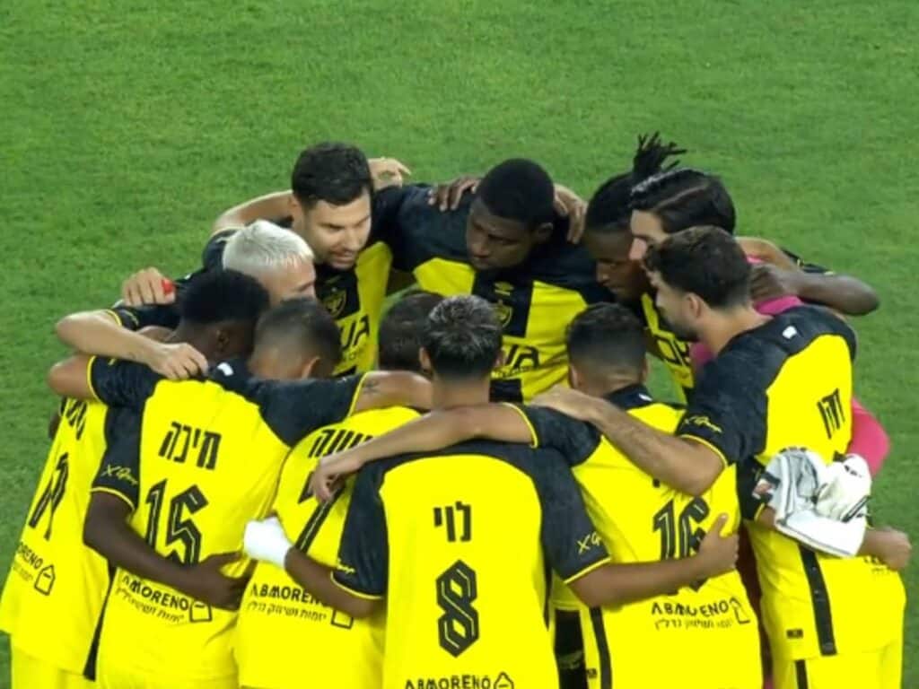 Beitar Jerusalem players celebrate a win at Sammy Ofer Stadium, showing unity before kickoff