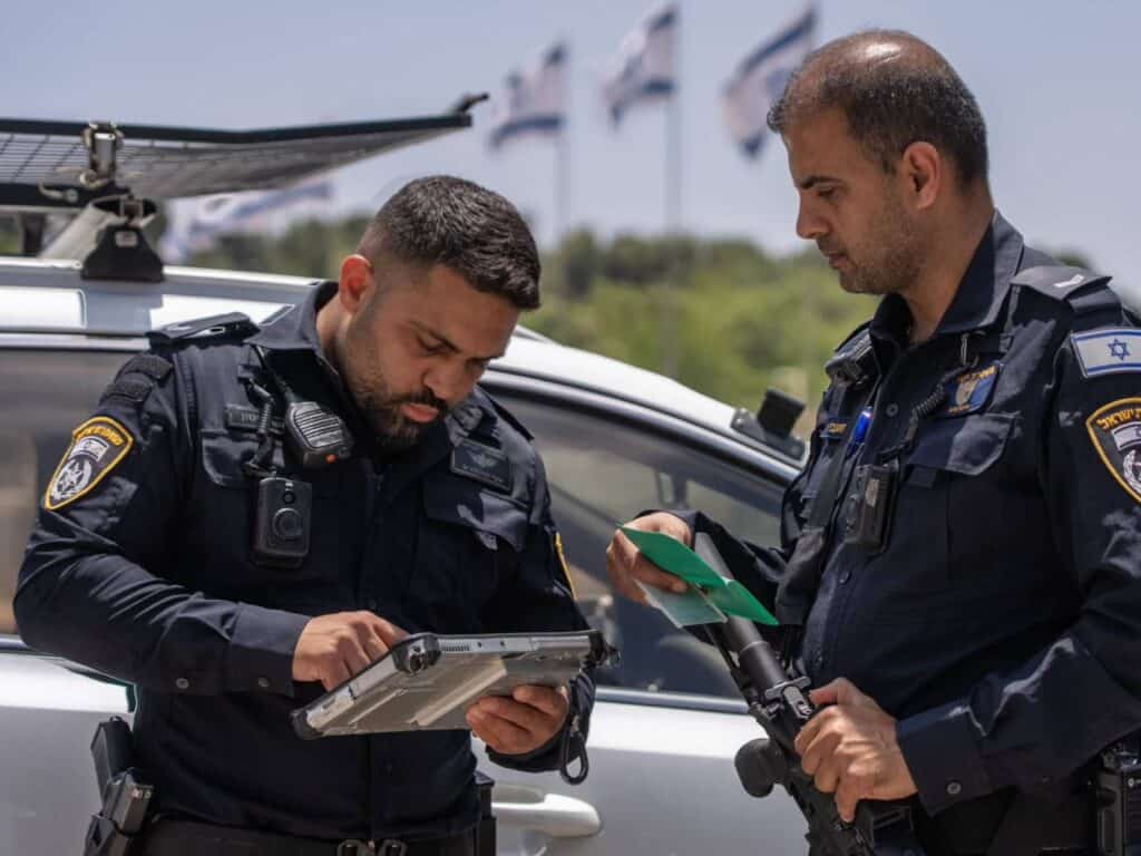 Jerusalem police officers operating advanced identification system during field operation en