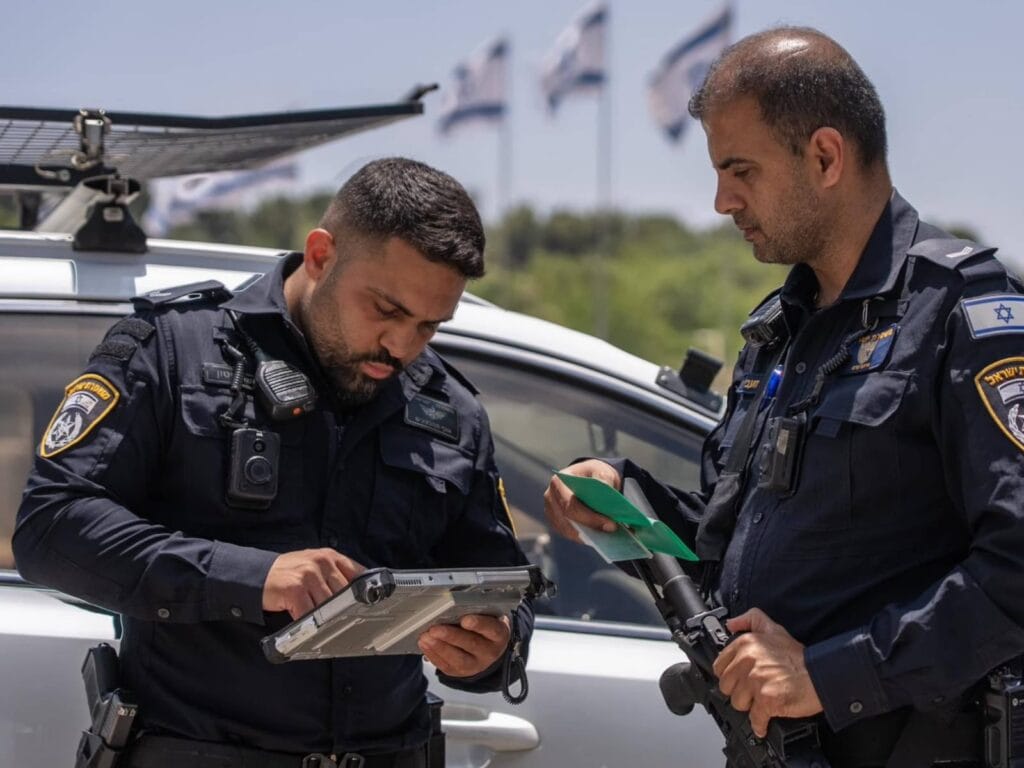 Jerusalem police officers operating advanced identification system during field operation he